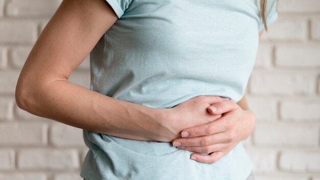 Woman having cramps indoors