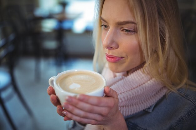 Woman having a cup of coffee in cafÃ©