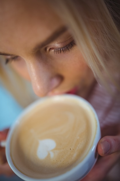 Woman having a cup of coffee in cafÃ©