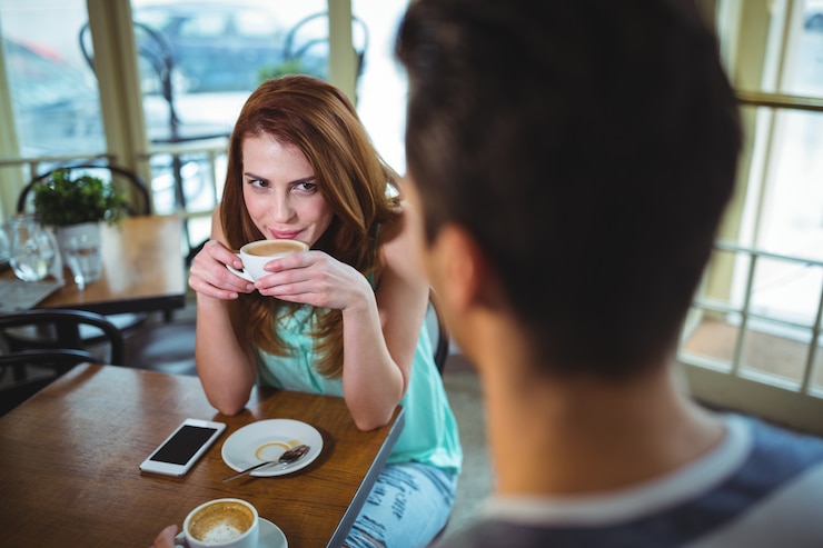 Free Photo woman having a cup of coffee in cafã©