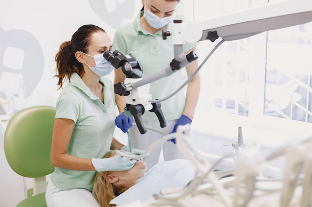 woman having dental treatment at dentist's office and woman is being treated for teeth.