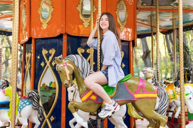 Woman having fun on the carousel