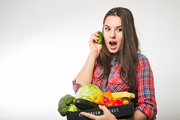 Woman having fun with cucumber