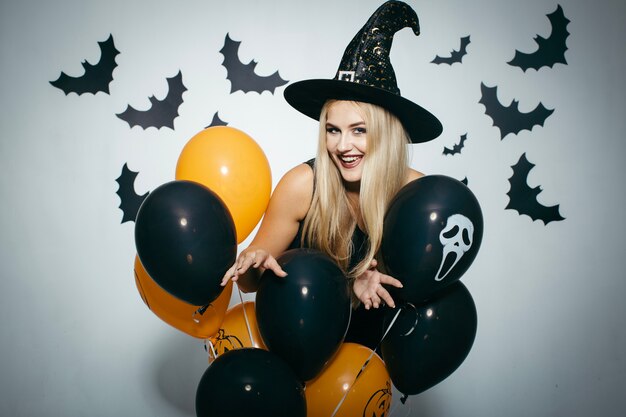 Woman having fun with Halloween balloons