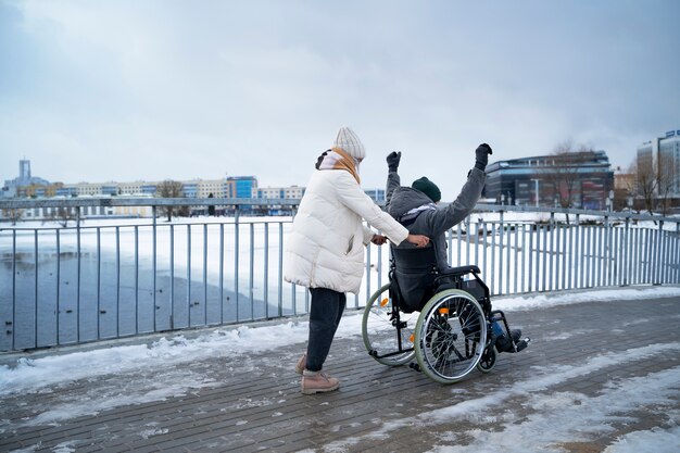 Woman having fun with her her disabled friend