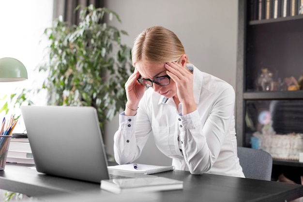 Free photo woman having a headache before class