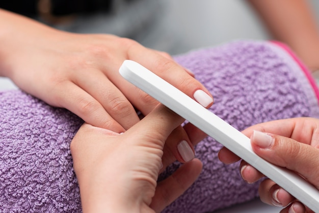 Woman having her manicure done close-up