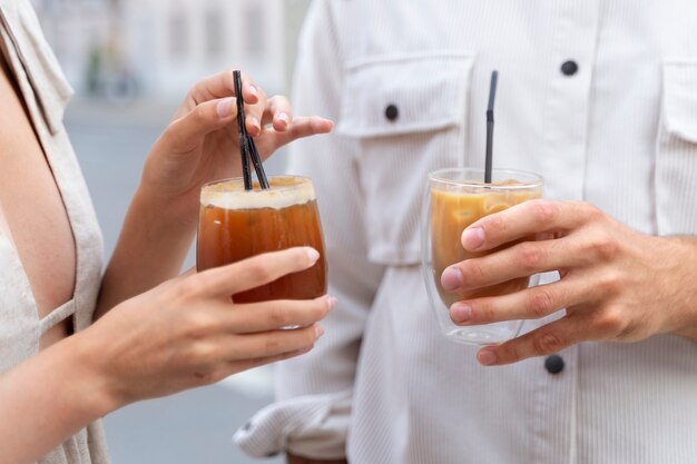 外でアイスコーヒーを飲む女性