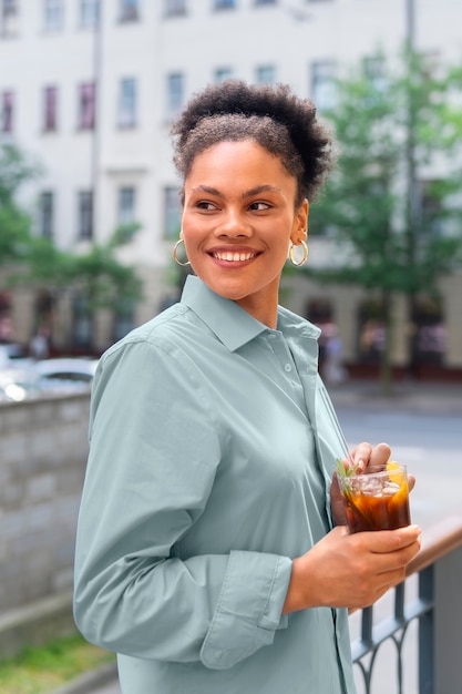 Woman having an iced coffee break outside