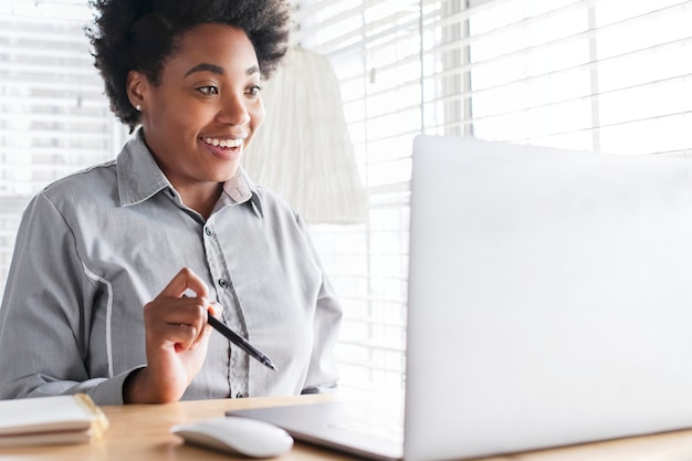 Free photo woman having an online class meeting through e-learning system