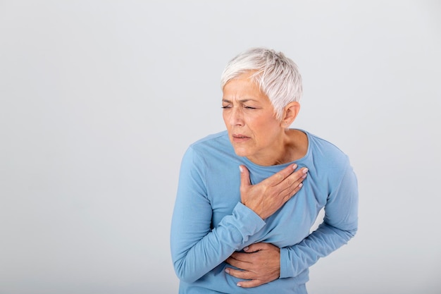 Woman having a pain in the heart area Heart Attack Painful Chest Health Care Medical Concept High Resolution Woman having heart attack at home