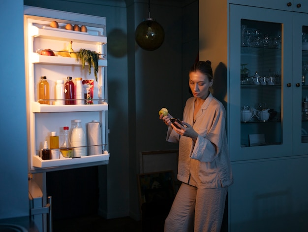 Free photo woman having snacks medium shot