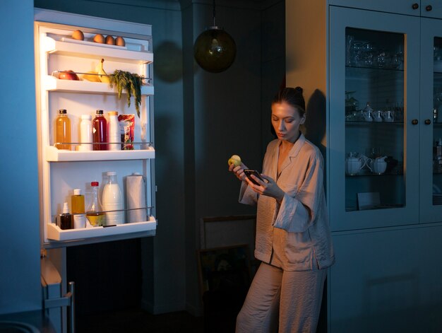 Woman having snacks medium shot
