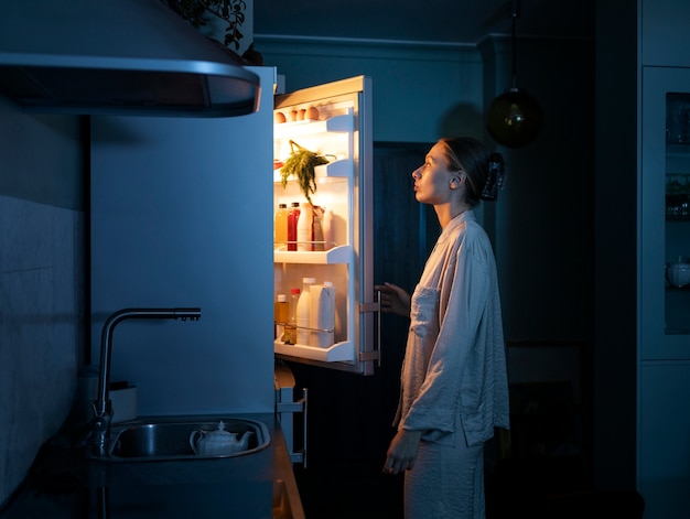 Free photo woman having snacks side view