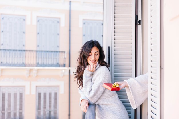 Woman having surprising gift from girlfriend