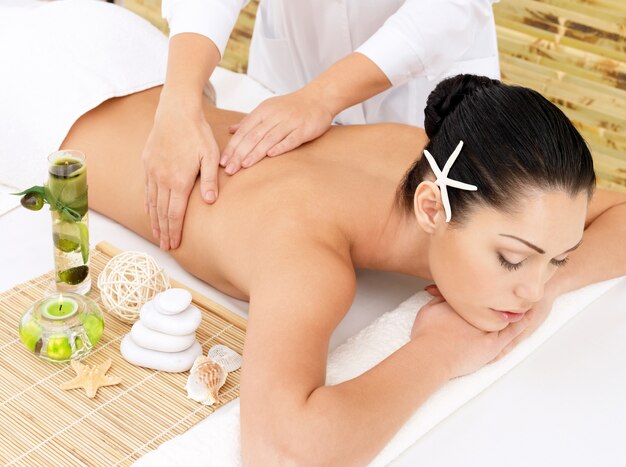 Woman having therapy massage of back in the spa salon. Beauty treatment concept.