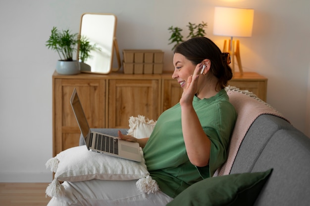 Woman having a video call at home on a laptop device