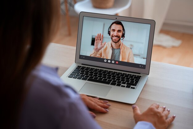 Woman having a video call at home on a laptop device