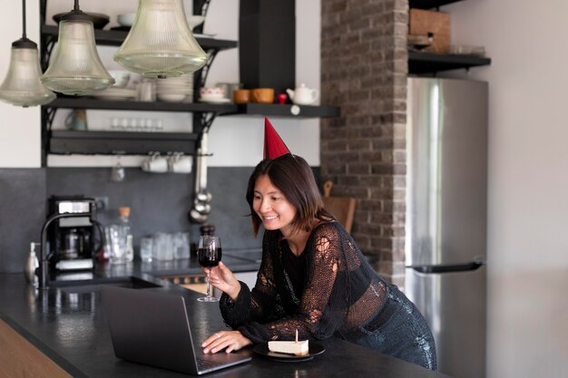 Woman having a video call with her family on her birthday