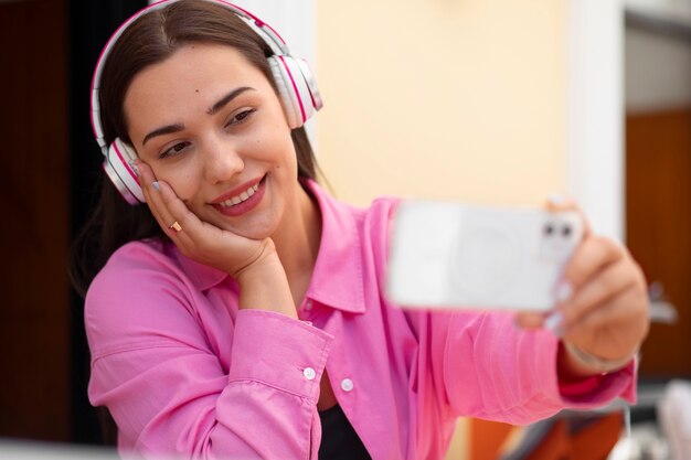 Woman having a videocall on smartphone while out in the city