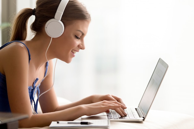 Woman in headphones learning language online