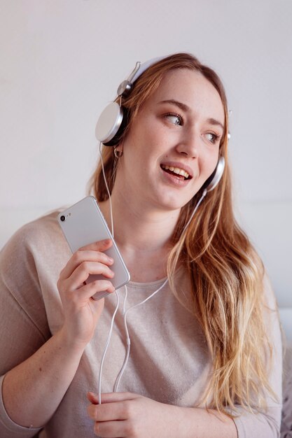 Woman in headphones singing