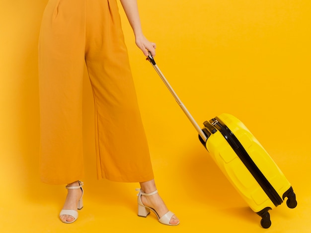 Woman in heels holding luggage