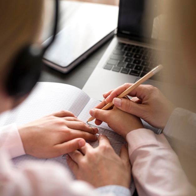 Woman helping girl in doing her homework