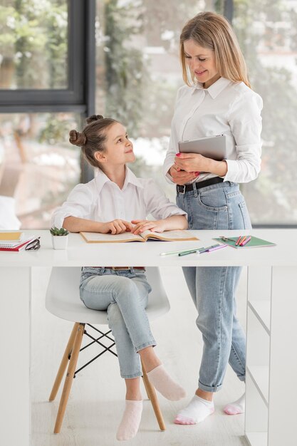 Woman helping her daughter