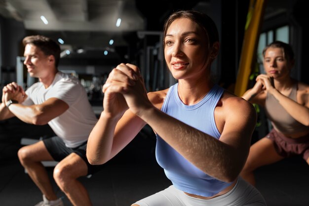 Woman helping man at gym