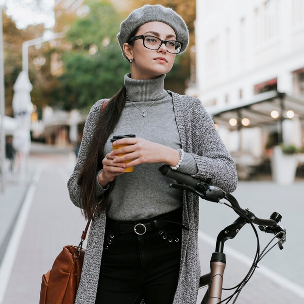 Woman and her bike drinking coffee