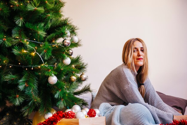 Woman next to her christmas tree