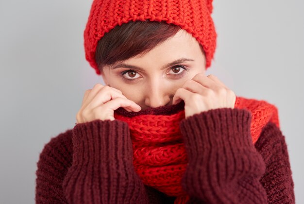 Woman hiding in warm clothes