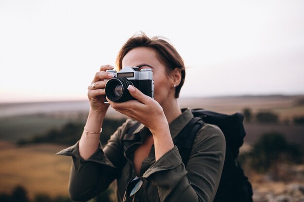 Woman hiking in the mountains and making photo