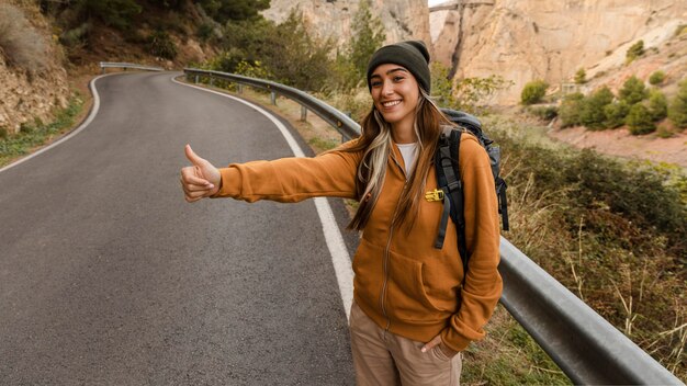 woman hitch-hiking for a car