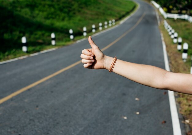 Woman Hitch Hiking on The Street Side Near The Broke Down Car