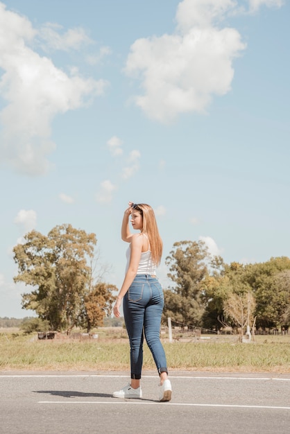 Free photo woman hitchhiking on a road