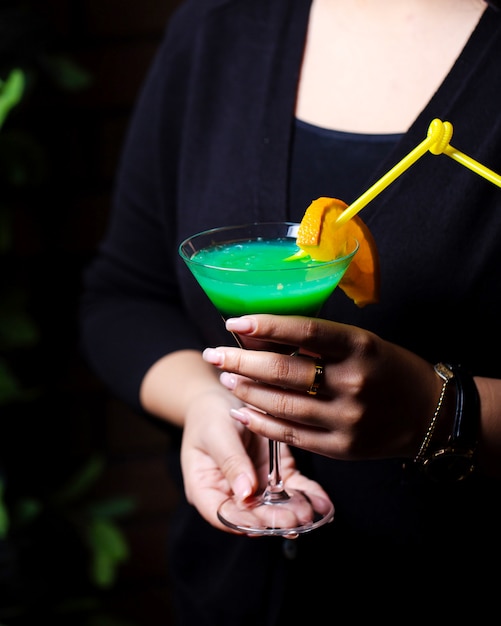 Woman hold cocktail with orange slice