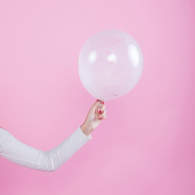 Free photo woman holding air balloon in hand