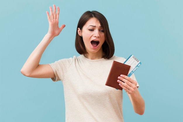 Woman holding airplane tickets and passport