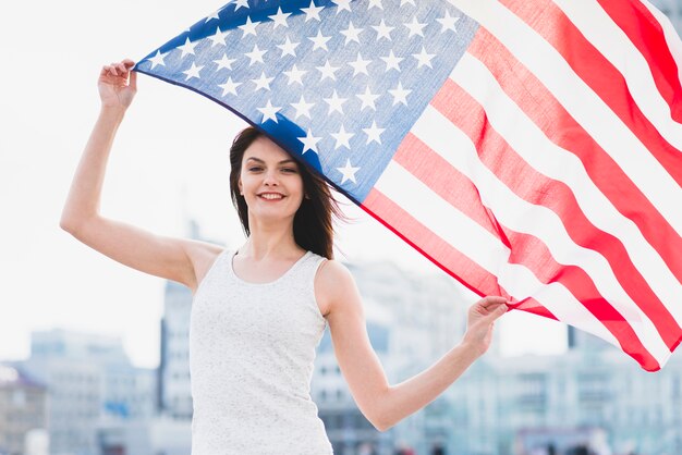 Woman holding American flan and waving it