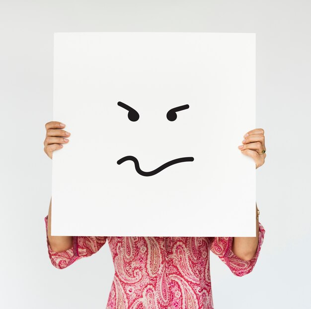 Woman holding angry banner cover her face