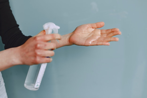 Woman holding antiseptic in her hands