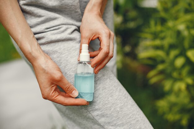 Woman holding antiseptic in her hands