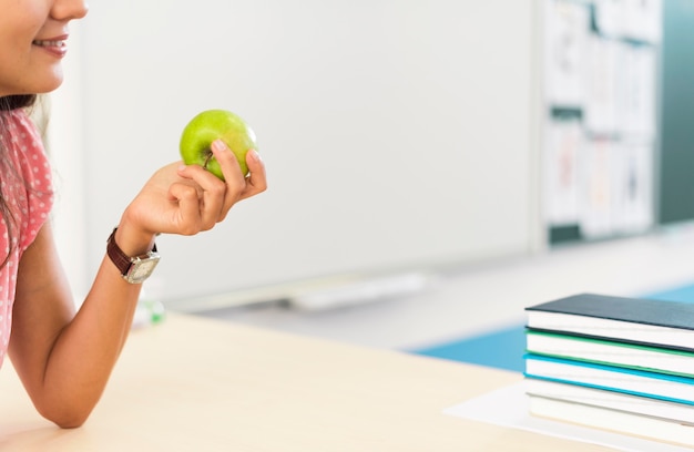 Free photo woman holding an apple with copy space