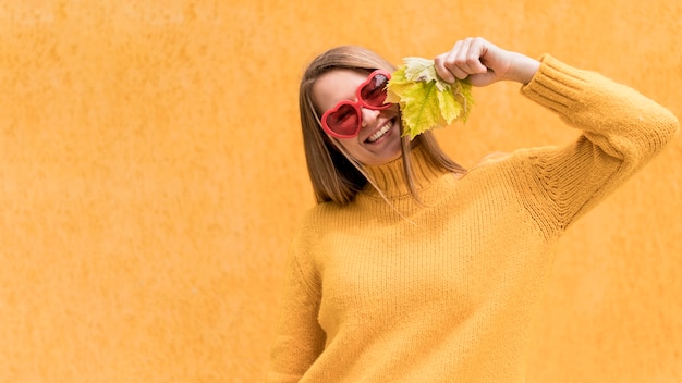 Woman holding an autumn leaf