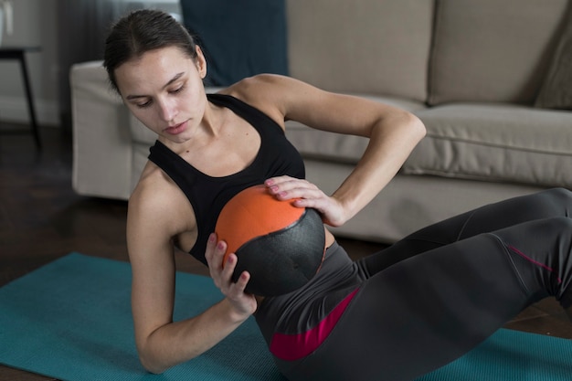 Woman holding ball while exercising