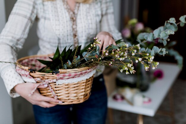 Woman holding basket with flowers