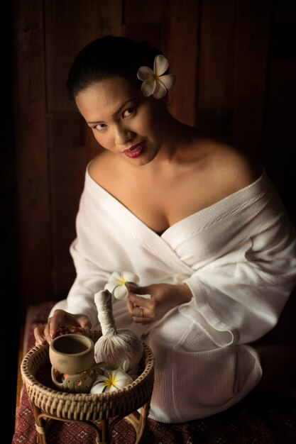 Woman holding a basket with items for a massage