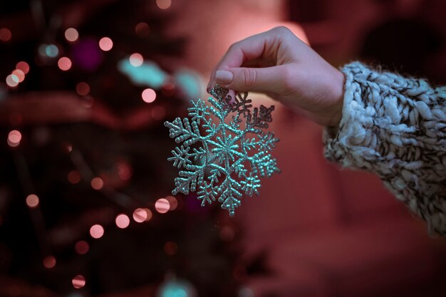 Woman holding big snowflake in hand